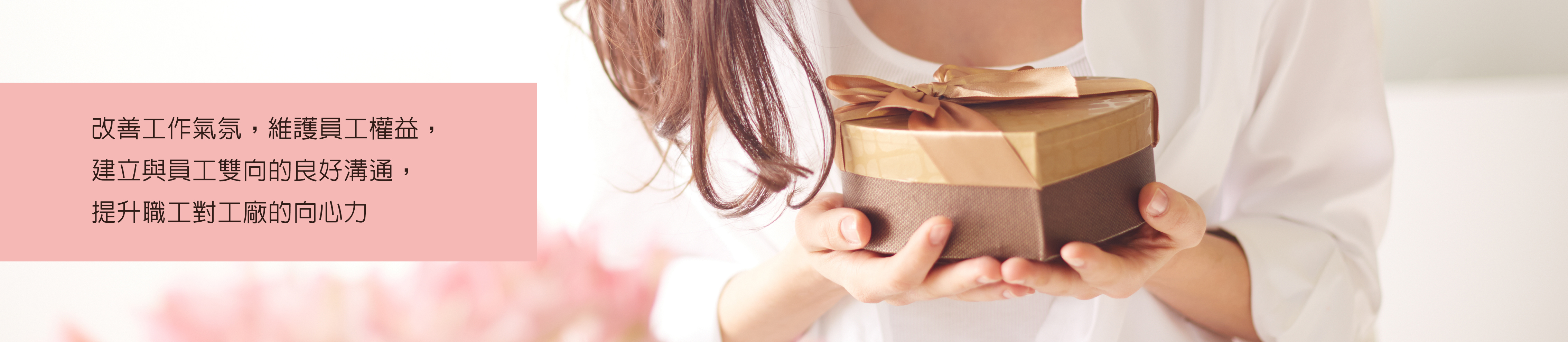 Calm female looking at heart shaped giftbox in her hands